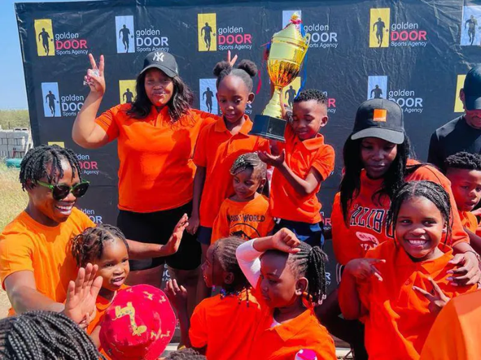 Glody Dube students holding trophy